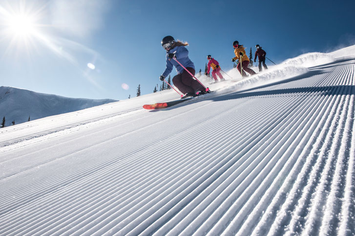 Kids-Skiing-On-The-Piste-With-A-Ski-Instructor