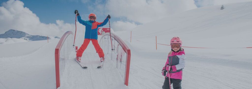 Two children skiing in a family ski area in Austria